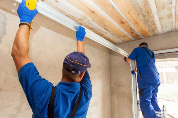 garage door installers putting in garage door